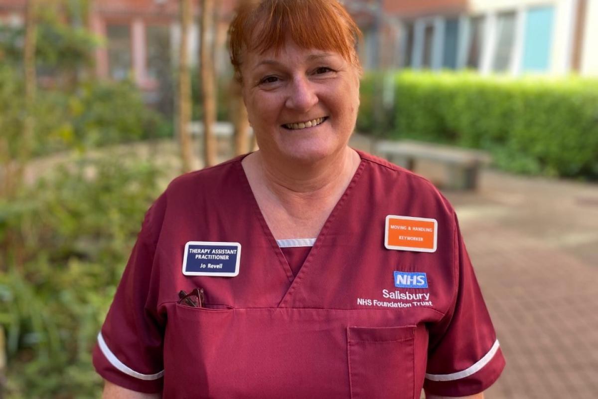 Headshot of Jo smiling in her NHS Uniform