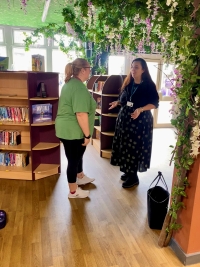 Two women chatting in a library