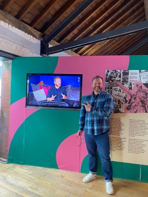 Robert Workman stands next to his section at a museum exhibition