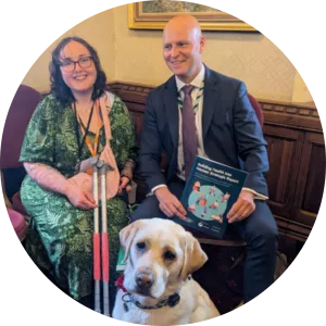 Martha, an expert by experience and member of the Building Health into Homes steering group, speaking with her local MP Max Wilkinson at the launch of the strategic report.