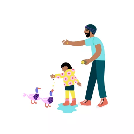 Dad feeding ducks with child