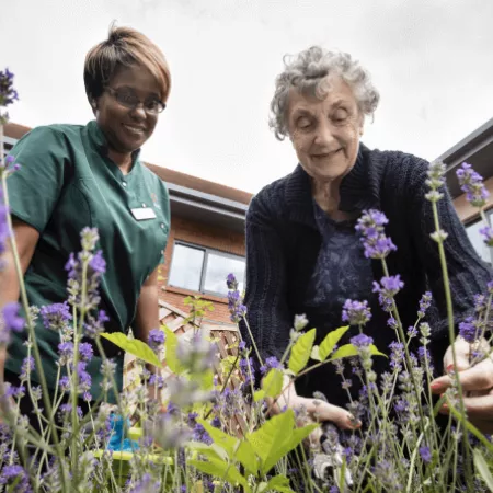 An occupational therapist and elderly lady in the garden
