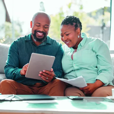 Image of two people smiling and signing forms