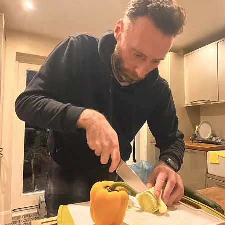Gary cutting vegetables demonstrating an occupation