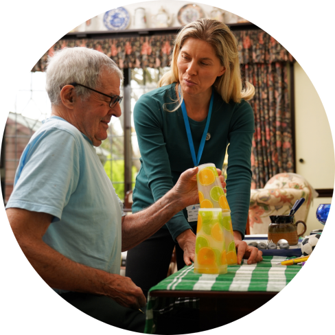 An OT works with an older person to develop fine motor skills